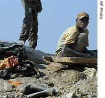 Miners handle stones on a hilltop of Mbola mines in Democratic Republic of Congo (File photo)