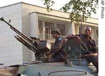 Congo troops sit on a tank in front of the house of ex-rebel leader Jean-Pierre Bemba in Kinshasa, Congo, 24 Mar 2007