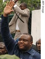 Jean-Pierre Bemba waves to a crowd gathered outside his house in Kinshasa