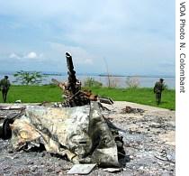 Bemba's guard stand next to downed helicopter
