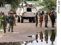 Soldiers and local people gather near a United Nations armoured vehicle in Kinshasa, Nov. 13, 2006 