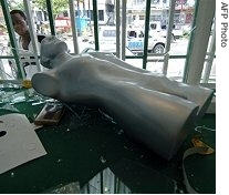 A man looks into a looted shop window, 24 March 2007, in Kinshasa, capital of the Democratic Republic of Congo