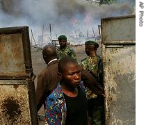 Remainder of a camp for militiamen is seen background in Kinshasa, Democratic Republic of Congo, July 27, 2006