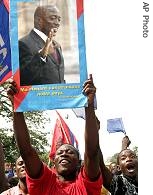 Government party supporters hold a poster of President Joseph Kabila