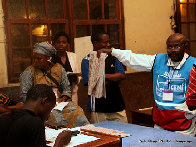 Observers witness votes being counted at a polling station in Kinshasa on Monday, November 28, 2011