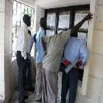 Voters check candidates' lists at a polling station